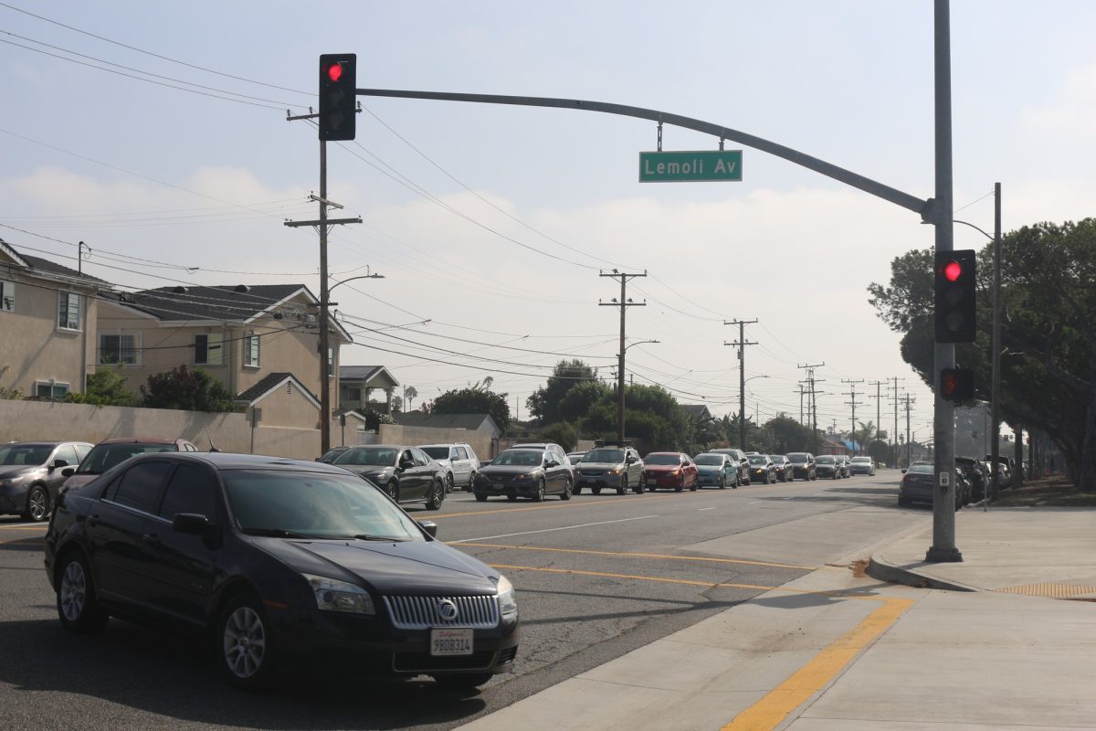 A line of cars turn into Lemoli Avenue from Manhattan Beach Boulevard to enter parking Lot C at El Camino College early in the morning on Thursday, Aug. 31, 2023. (Delfino Camacho | The Union)
