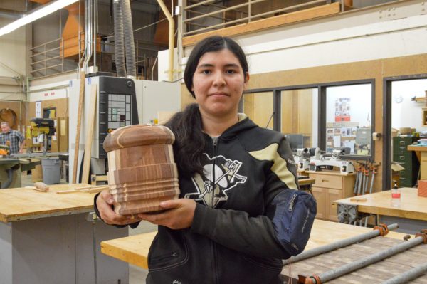 El Camino College student Daniela Romero holds her soon-to-be lidded container while posing in the woodworking class inside the El Camino woodworking workshop on Wednesday, Nov. 29. (Juan Garcia | The Union)