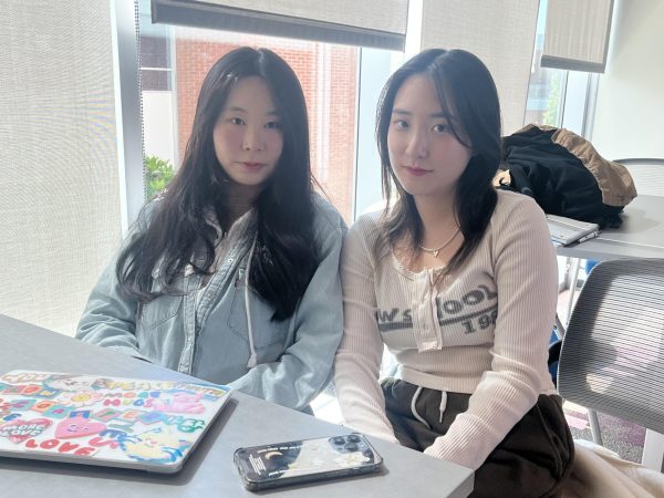 Hwanjoo Jeong, left, 21, a business and economics major from South Korea and Eunseo Hwang, 20, neuroscience major, sit together in the Study Center on the second floor of the Schauerman Library on Tuesday, Oct. 3. (Nasai Rivas | The Union)