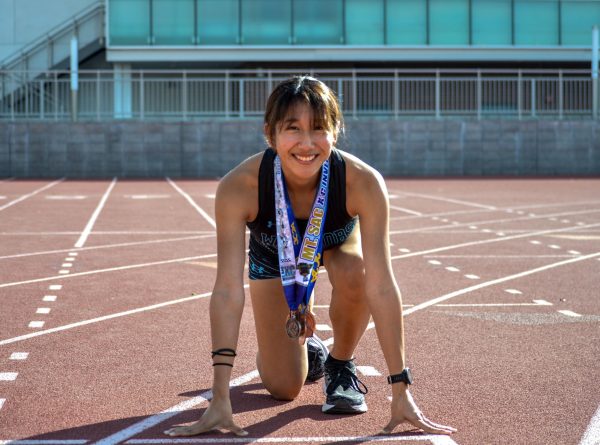 Sequoia Gonzales giving an amazing smile on the track while posing with her medals ready to take off on Dec 11.(Caleb Smith|The Union)