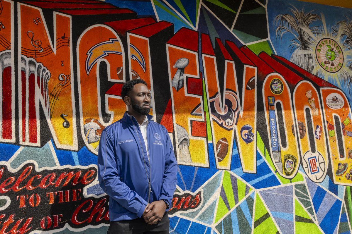 El Camino College Trustee Brett Roberts takes a moment to show his respects to the city of Inglewood at a mural in front of Antojitos Martin on Oct. 13. Roberts represents Inglewood and Ladera Heights in his Area Seat One position on the Board of Trustees. (Khoury Williams | Warrior Life)
