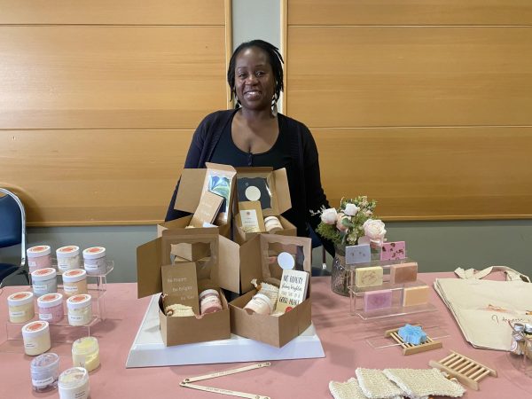 Francia Telesford, 39, founder of Gracelamp Wellness, displays handmade varieties of body butter, soaps and wellness gift boxes at her booth as part of the Mini Black Market Flea and Taste of Soul event happening in the East Dining Room above the bookstore.