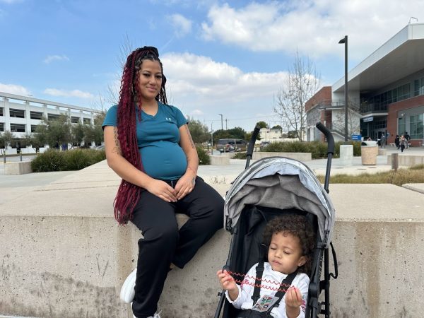 Business administration major Luta Tukutau, 32, sits outside the Student Services Building with her daughter Sunshine. She will spend Valentine’s Day evening with her partner Brandon and their daughter. (Eddy Cermeno | The Union)