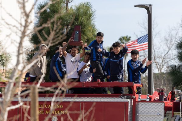 Players from El Camino College's men's soccer team celebrate their 2023 State Championship atop a firetruck as they parade through campus on Thursday, Feb. 15. The championship title ended a 31 year drought in the men's soccer program. (Ethan Cohen | The Union)