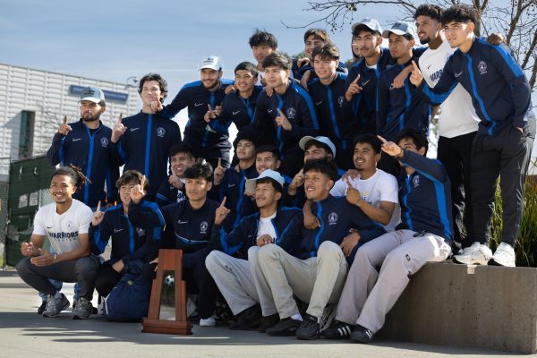 The El Camino College men's soccer team raise their fingers showing they are number one in front of the Student Services building before embarking on their victory parade through campus on Feb. 15. Warriors soccer won the 2023 3C2A State Championships this past December. (Ethan Cohen | The Union)