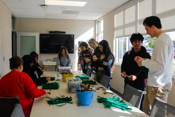El Camino College students participating in the craft of condom roses in honor of Valentine's Day. El Camino's Student Health Center's opening day involved a walk through, snacks, and crafts, Feb. 14. (Monroe Morrow | The Union)