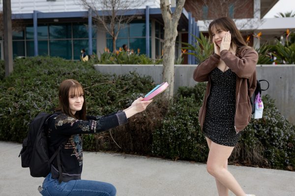 Katie Ceregatti, 21, hands chocolates and a card to her friend Kayli Iwamoto, 19, on Valentine&squot;s Day at El Camino College. Ceregatti and Iwamoto are spending the day together as friends and plan on "reclaiming the day" as theirs. (Ethan Cohen | The Union)
