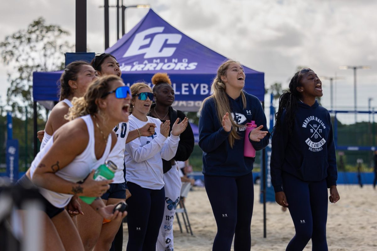 Players from the El Camino College Beach Volleyball team celebrate as the No. 4 duo scores a point in the third set of play against the Long Beach City College Vikings. The Warriors beat the undefeated Vikings 3-2 on Friday, March 29, at the ECC Sand Courts. (Ethan Cohen | The Union)