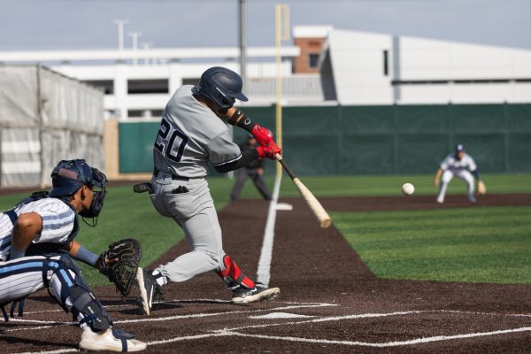 Cerritos third baseman Anthony Bassett cracks a single to left field at Warrior Field on Thursday, March 7. The Cerritos Falcons beat the El Camino College Warriors 8-5 in an extra-innings rally. Bassett went 2-5 with one RBI. (Ethan Cohen | The Union)