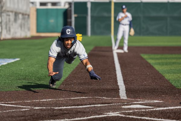 Cerritos shortstop DJ Massey slides for home plate after an error by El Camino's second baseman Connor Meidroth. The Cerritos College Falcons beat the El Camino College Warriors in extra innings 8-5. Massey went 2 for 5 with one RBI. (Ethan Cohen | The Union)