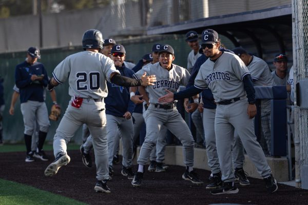 The Cerritos Falcons dugout celebrates after they score three runs off of an error by Warriors left fielder Ryan Matsukawa at Warrior Field on March 7. The Cerritos College Falcons beat the El Camino College Warriors 8-5 in an extra-innings rally. (Ethan Cohen | The Union)