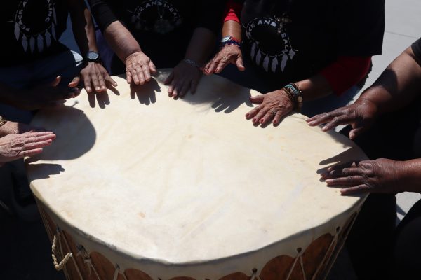Participants of the Native American Drum Circle create rhythms on the Grandmother Drum near the El Camino College Art Gallery on Tuesday, March 19. (Jamila Zaki | The Union)