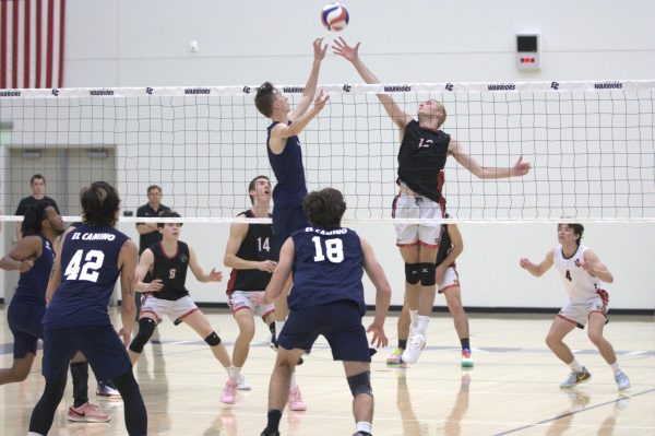 Warriors sophomore No. 14 Jacob Flanagan and Vaqueros sophomore No. 12 Cameron Brown both jump at the ball to earn a point for their team in the men's volleyball game at the ECC Gym Complex on Friday, March 8. (Renzo Arnazzi | The Union )