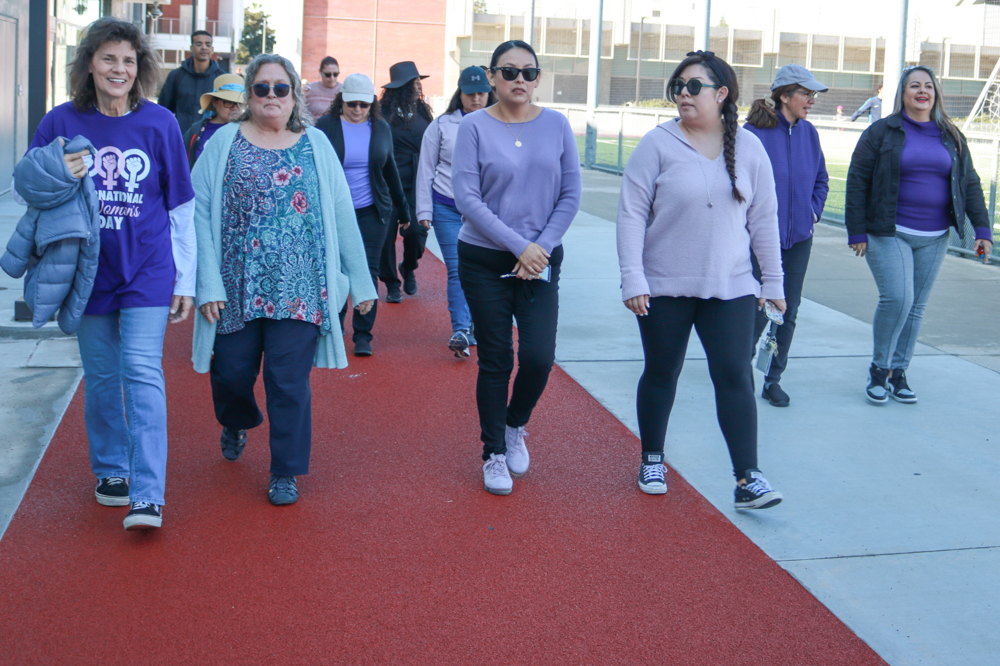 Participants walk around El Camino's PE & Athletics Field in celebration of International Women's Day on Thursday, March 7. (Joseph Ramirez | The Union)