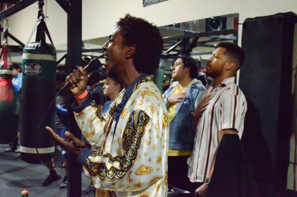 El Camino College student Isaiah Williams (right), music major, sang the opening National Anthem at "Sweet Science Boxing Gym & MMA" for the "Fight Night" fundraising event. (Slihm Davis | The Union)