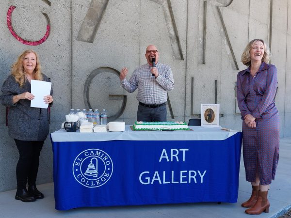 Carrie Lockwood, left, and Kate Devine-Brady, right, laugh as Michael Miller, center, dedicates the cake to “all women ever in existence on Earth,” during his speech at the Aline Barnsdall cake-cutting ceremony on Thursday, March 28. (Nikki Yunker | The Union)