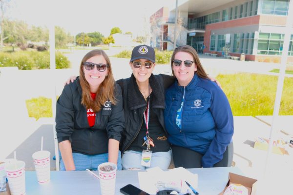 From left, Katie Swenson, Kelsey Iino and Breeanna Bond pose under a tent at the Student Services Plaza on Saturday, March 16. Swenson, Iino and Bond helped organize this year's Onizuka Space Science Day. (Joseph Ramirez | The Union)