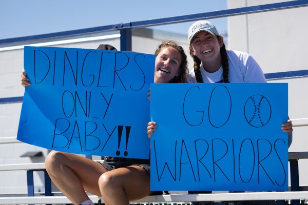 El Camino Beach Volleyball players Ryan D'Angelo (left) and Bridget Dorr cheer on the Warriors in the stands during the final home game of the season on Friday, April 26. It is common to see Warriors teams cheering on other sports at home games. (Ethan Cohen | The Union)