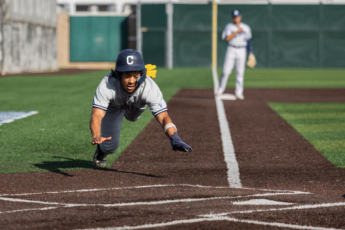 Cerritos shortstop DJ Massey slides for home plate after an error by El Camino's second baseman Connor Meidroth. The Cerritos College Falcons beat the El Camino College Warriors in extra innings 8-5 on Thursday, March 7. Massey went 2 for 5 with one RBI. (Ethan Cohen | The Union)