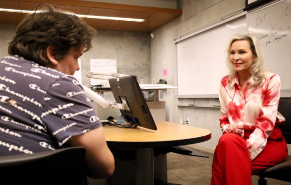 El Camino College Screenwriting professor Kim Krizan sits and talks with student Daniel Garcia, 20, while on a short break during her three-hour Wednesday screenwriting class on April, 4. Garcia asked Krizan for advice on his already written screenplay, "Life of a Teen" which is 143 pages long. While Krizan said he could work on shortening, she praised Garcia saying he had already done the hardest part, he had finished his script. (Delfino Camacho | The Union)