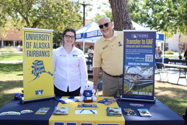 University of Alaska, Fairbanks transfer credit manager Ariel Baumgartner, left, and Palmer Muntz, senior regional admissions counselor, participate in the El Camino College Transfer Center's Spring University Fair on Thursday, March 21 on the ECC Library Lawn. UAF is a leader in Arctic research. (Elsa Rosales | The Union)