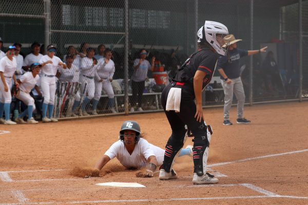 El Camino infielder Cheyenne Navarro slides to home base and scores a home run during the first inning on Thursday, April 25 against Long Beach. (Jamila Zaki | The Union)