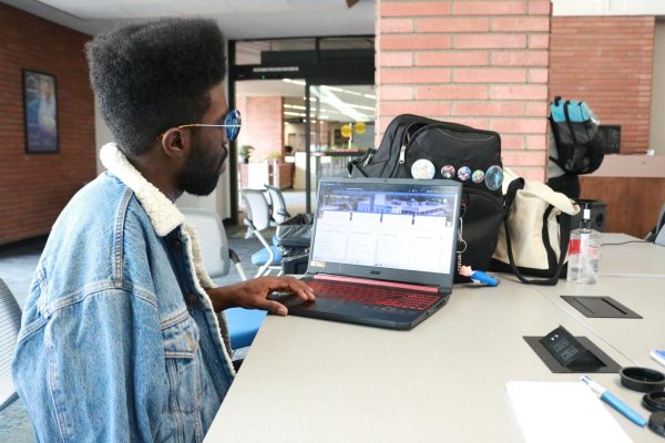El Camino College student Jahquist Williams, 22, looks at the new MyECC portal on his laptop in the Schauerman Library on Thursday, April 4. (Joseph Ramirez | The Union)