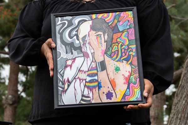 Virginia Rose holds one of the paitnings she sold at the El Camino College Maker's Fair hosted by the Art Gallery. Rose said that she had a succesful day selling her artwork. She is one of 11 vendors who set up tables to sell and promote their artwork. (Ethan Cohen | The Union)