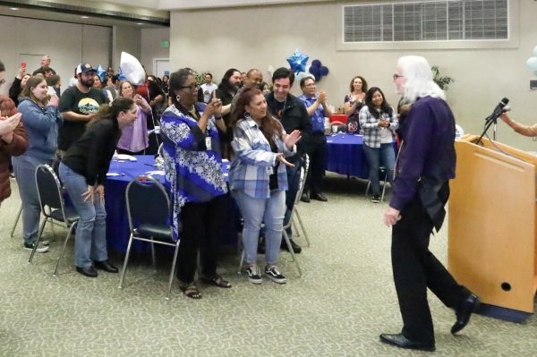 Robin Dreizler receiving a round of applause from family, friends and colleagues in celebration of his retirement in the East Dining Room at El Camino College on April 17. (Nick Miller | The Union)