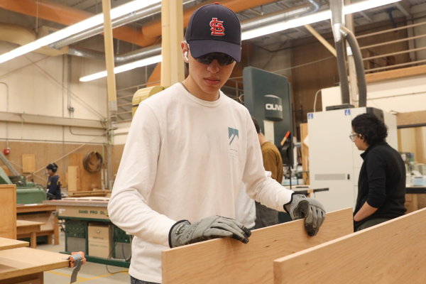 Domingo Castro, a construction student at El Camino College works with wood in order to build a bookshelf during a cabin-making class on Saturday, April 20, in the Construction Technology Building. (Warrior Life | Greg Fontanilla)