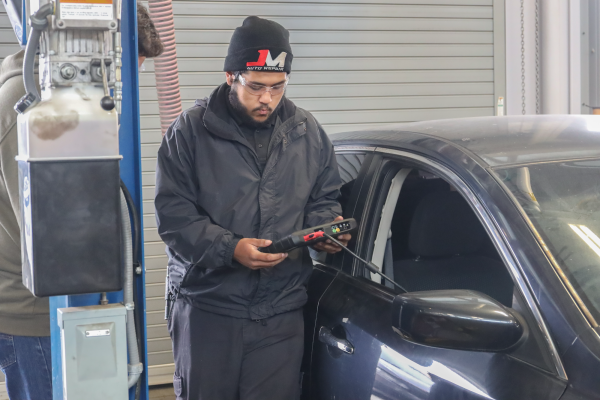 Juan Pantoja, an automotive technology student, checks for hot and cold readings on an OBD scanner during a lab session on Monday, April 22 in the Center of Applied Technology Building. Pantoja took an electrical and computer controlled systems class in the automotive technology program to learn how electrical functions work in automobiles. He plans on working for a European car dealership upon finishing the program. (Greg Fontanilla | Warrior Life)