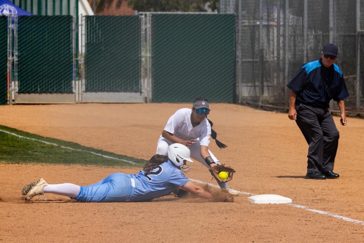 Moorpark+College+designated+player+Alexa+Paradis+slides+into+first+base+during+a+pickoff+attempt+by+Warriors+pitcher+Madilyn+Radeke+at+El+Camino+Colleges+softball+field+on+Friday%2C+May+3.+El+Camino+won+3-0+against+Moorpark+in+Game+1+of+the+3C2A+Southern+California+Regionals.+%28Ethan+Cohen+%7C+The+Union%29