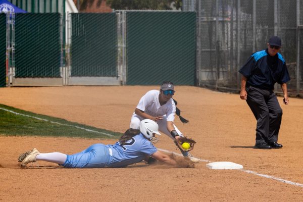 Moorpark College designated player Alexa Paradis slides into first base during a pickoff attempt by Warriors pitcher Madilyn Radeke at El Camino Colleges softball field on Friday, May 3. El Camino won 3-0 against Moorpark in Game 1 of the 3C2A Southern California Regionals. (Ethan Cohen | The Union)