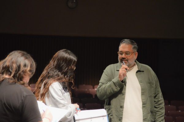 Nathan Singh, director of "Lost Girl" and theater professor, guides the ensemble with a prospective insight, providing precise notes and directions to the stage managers and actors. (Caleb Smith | The Union)