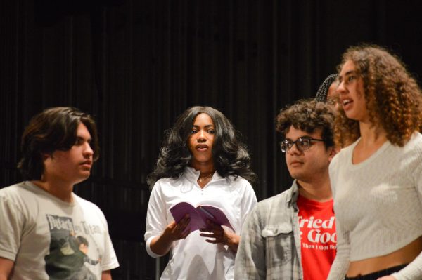 Under bright stage lights, four actors with scripts in hand immerse themselves in the raw emotion of “Lost Girl” during the April 17 evening rehearsal at the Campus Theatre. (Caleb Smith | The Union)