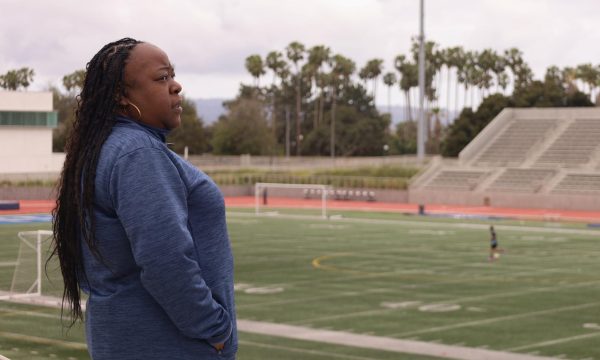 El Camino College Basic Needs Coordinator overlooks the Murdock Stadium football field on a gloomy morning. (Delfino Camacho | The Union)