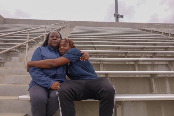 Sharonda Barksdale and student athlete Chance Williams embrace on the Murdock Stadium bleachers on April 25. Basic Needs Coordinator Barksdale first met Williams when he was looking for help enrolling to El camino College. Williams credits Barksdale with helping him not just with his education but with life. (Delfino Camacho | Warrior Life)