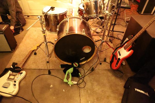 A stuffed Kermit the Frog sits in front of Willowake’s instruments before a house show in Maywood, California. The stuffed Kermit accompanies the band in a lot of their shows. (Delfino Camacho | Warrior Life)