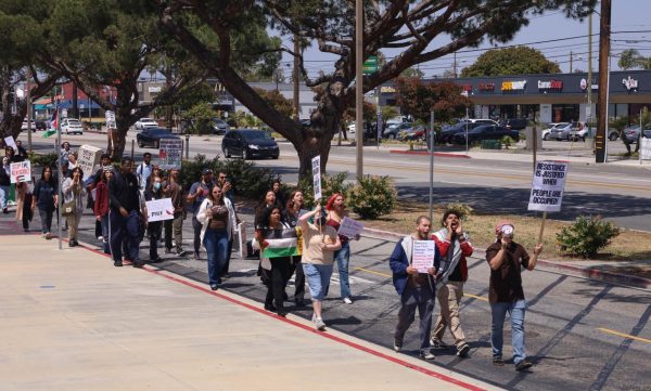 Marching students, employees and community members, including former Associated Students Organization Director of Finance Uzair Pasta (second fro right) make their way towards the El Camino College Administration Building as part of the student led teach-in for Palestine. (Delfino Camacho | The Union)