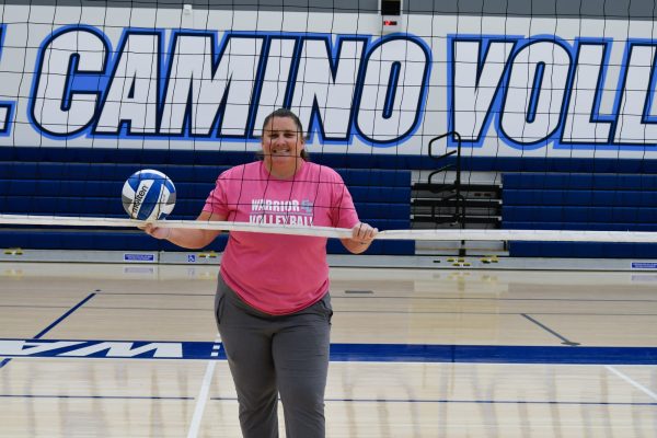 El Camino volleyball coach Liz Hazell, former state MVP, smiles for a photo in front of her home court net. Hazell, who led the team to state championships as a player, now inspires the next generation of volleyball players from the sidelines. (Eric Alvarez | The Union)