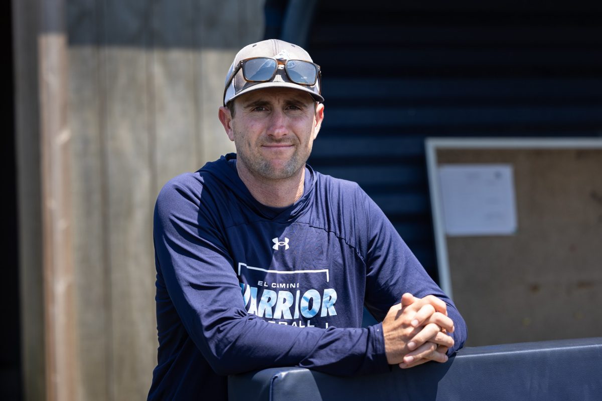 Grant Palmer rests on the edge of the El Camino College Warriors dugout during a routine practice at Warrior Field on Wednesday, April 24. (Ethan Cohen | The Union)
