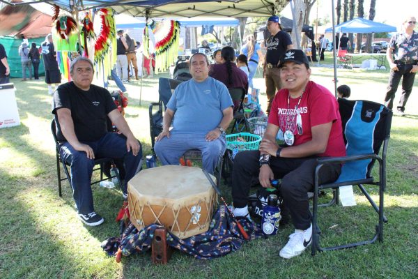 Wildhorse Singers (L-R) Art Neri, Jorge Lechuga and El Camino College film major Tyler Notah serve as Head Drum at the 30th Anniversary Ohlone "Big Time" Gathering & Pow Wow at Tony Cerda Park in Pomona, Calif., on Sunday, April 28. Notah is a content creator with over 44,000 followers on his TikTok channel @native.hustle. (Elsa Rosales | Warrior Life)