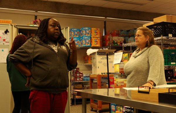 Basic Needs Coordinator Sharonda Barksdale takes a moment to strategize with Special Services Professional Kim Cameron during a busy afternoon rush on Tuesday, March 12. (Delfino Camacho | The Union)