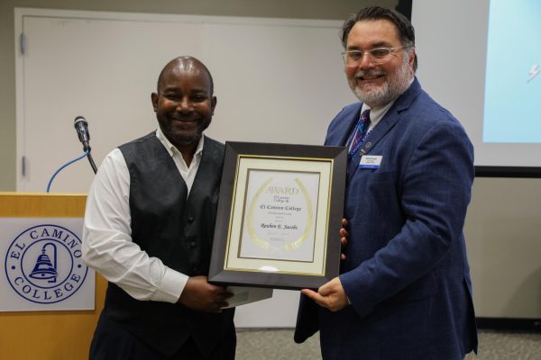 Reuben Jacobs, a part-time faculty member and Carlos from El Camino College, received an award from Carlos Lopez, vice president of academics, for the "ECC Distinguished Faculty and Staff Award Reception" ceremony on April 24 (Dayana Rodriguez | The Union).