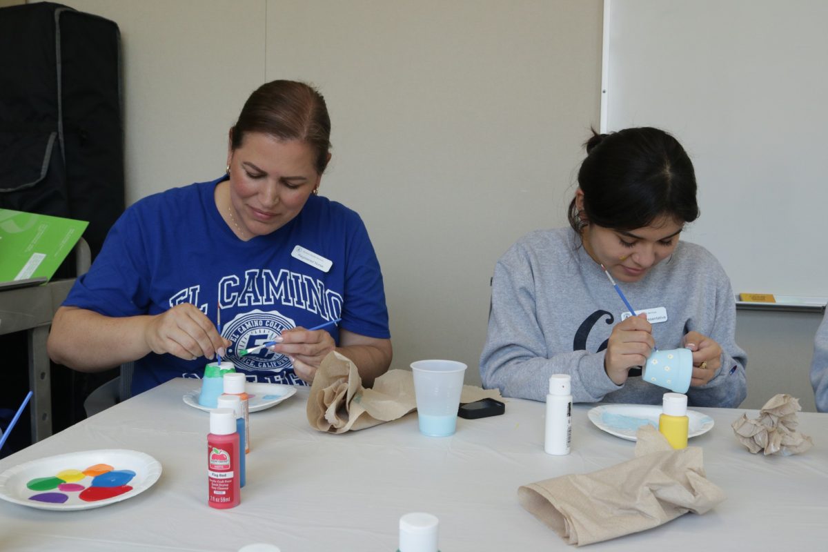 Registered nurse and event organizer Lina Berrio, left, paints her pot along with student Liliana Romero in the Student Health Center Conference Room on May 28, 2024. Berrio organized the event to help students destress from finals week.  (Joseph Ramirez | The Union)