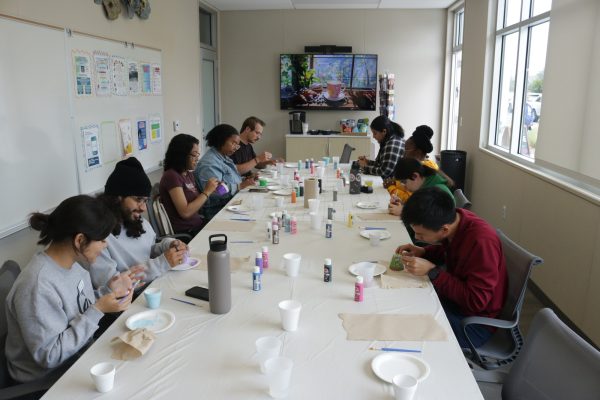 In the Student Health Center conference room students paint pottery together to have some peace during finals. May 28, 2024. (Joseph Ramirez | The Union)