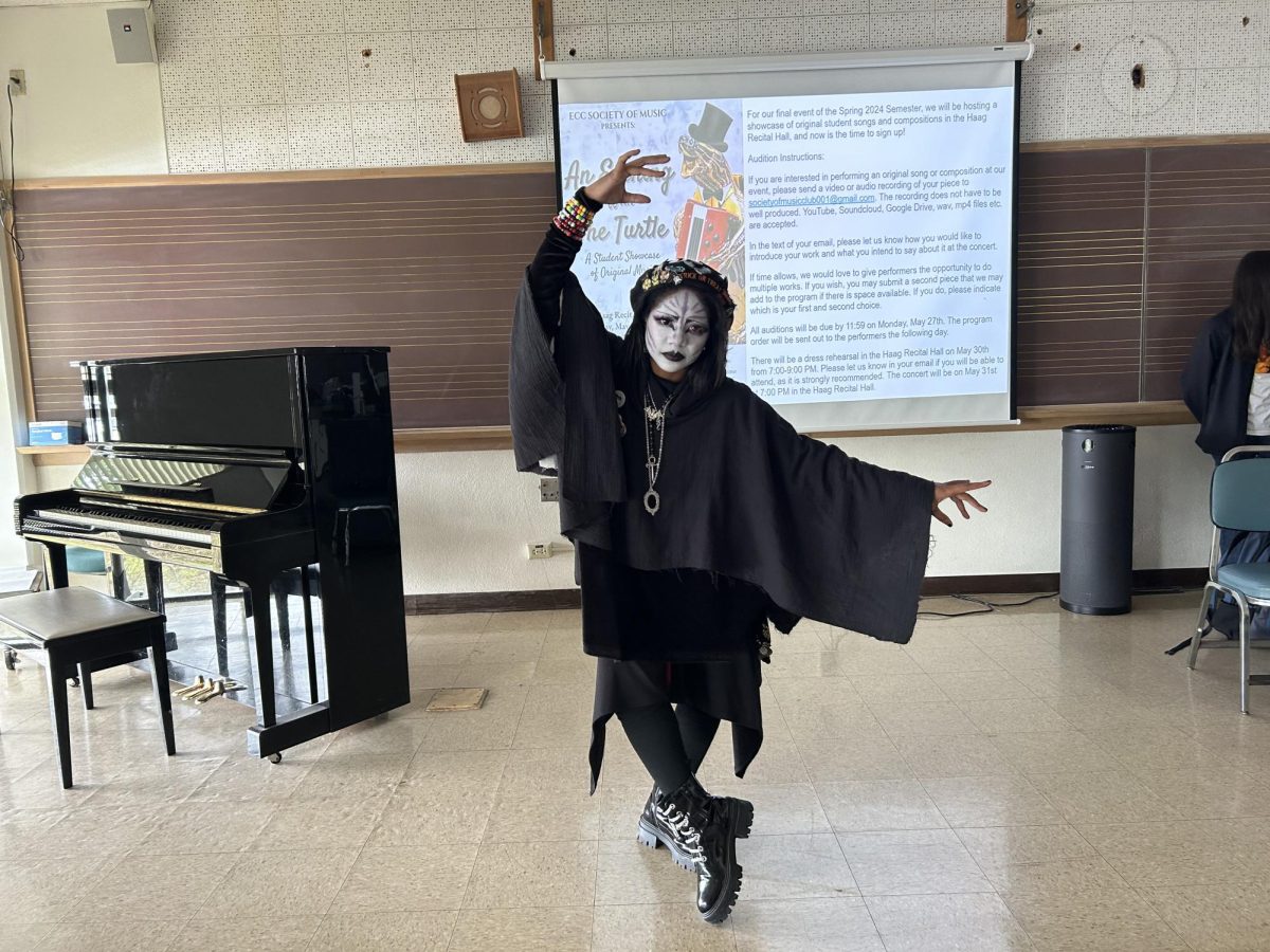 21-year-old fashion major who goes by Slade shows off her outfit in Room 131 of the Music Building on Thursday, May 16, during the Society of Music Clubs meeting. Slade later gave a presentation on goth rock music. (Tommy Kallman | The Union)