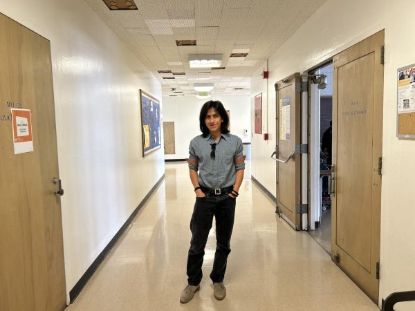 Society of Music club vice president Ian Mendoza smiles for the camera outside of Music room 131, where the club hosts its meetings. (Tommy Kallman | The Union)