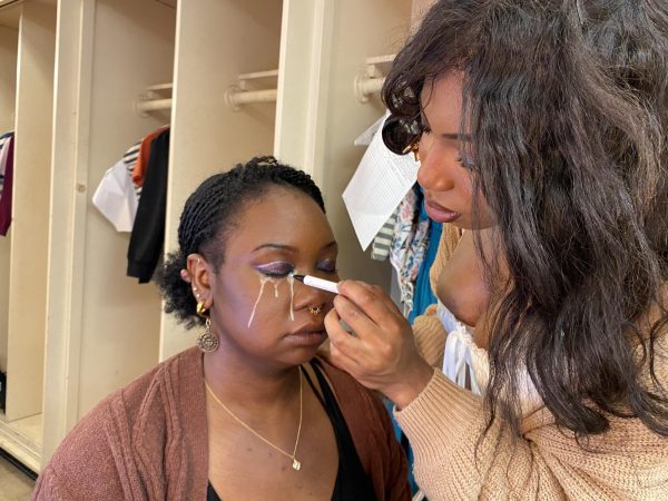 “Wendy C,” played by 19-year-old theater major Nyla Owusu, draws glitter tears on “Wendy A,” played by 20-year-old theater major Meyonni Varnado. The glitter tears are a makeup choice used by the three actors playing Wendy. (Caleb Smith | The Union)