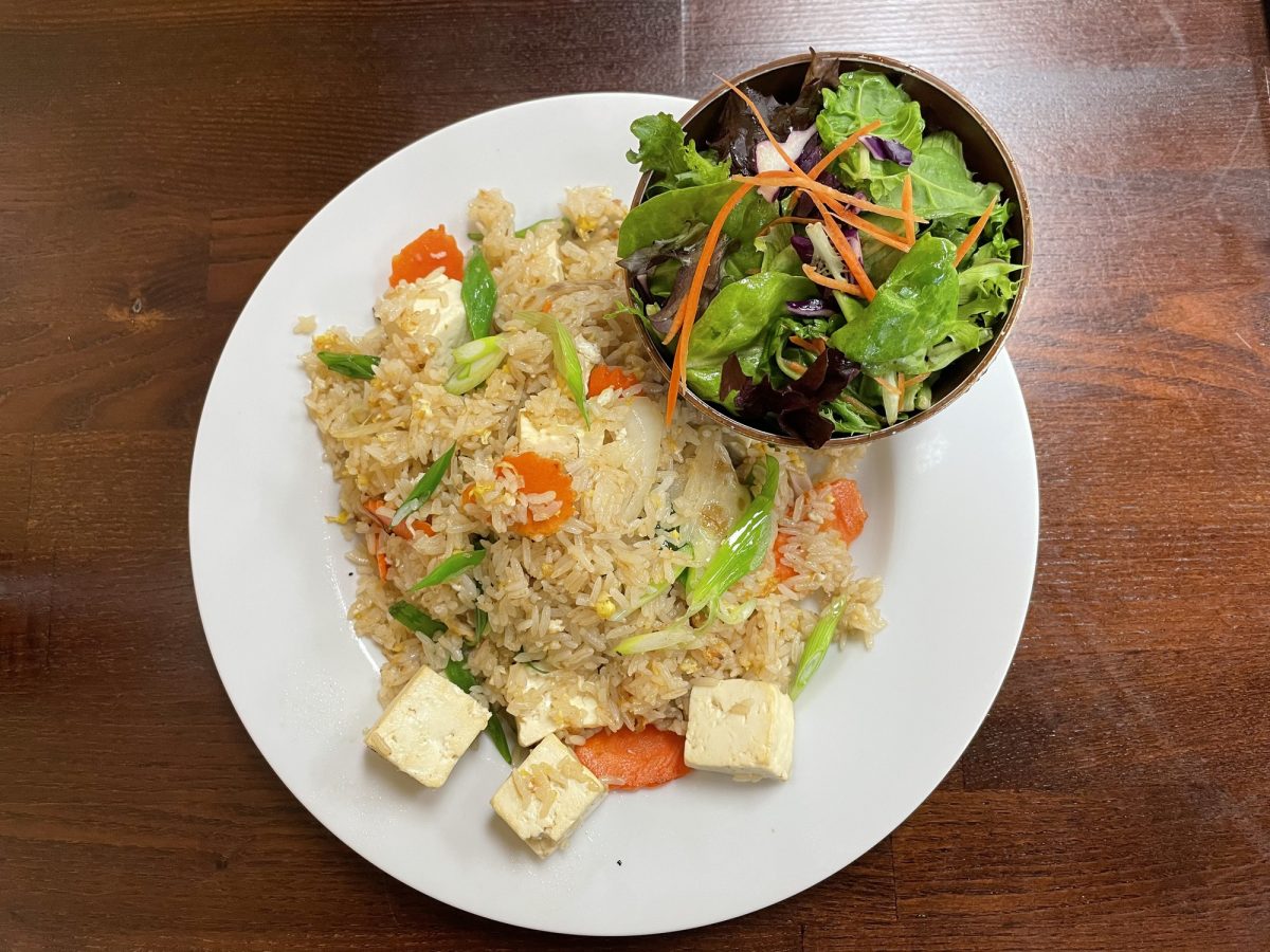 The Thai fried rice is fluffy and fragrant with an abundance of velvety chunks of tofu, translucent slices of onion, and golden fried eggs. Diners can also pick chicken or shrimp instead of tofu. (Erica Lee | Warrior Life) Photo credit: Erica Lee